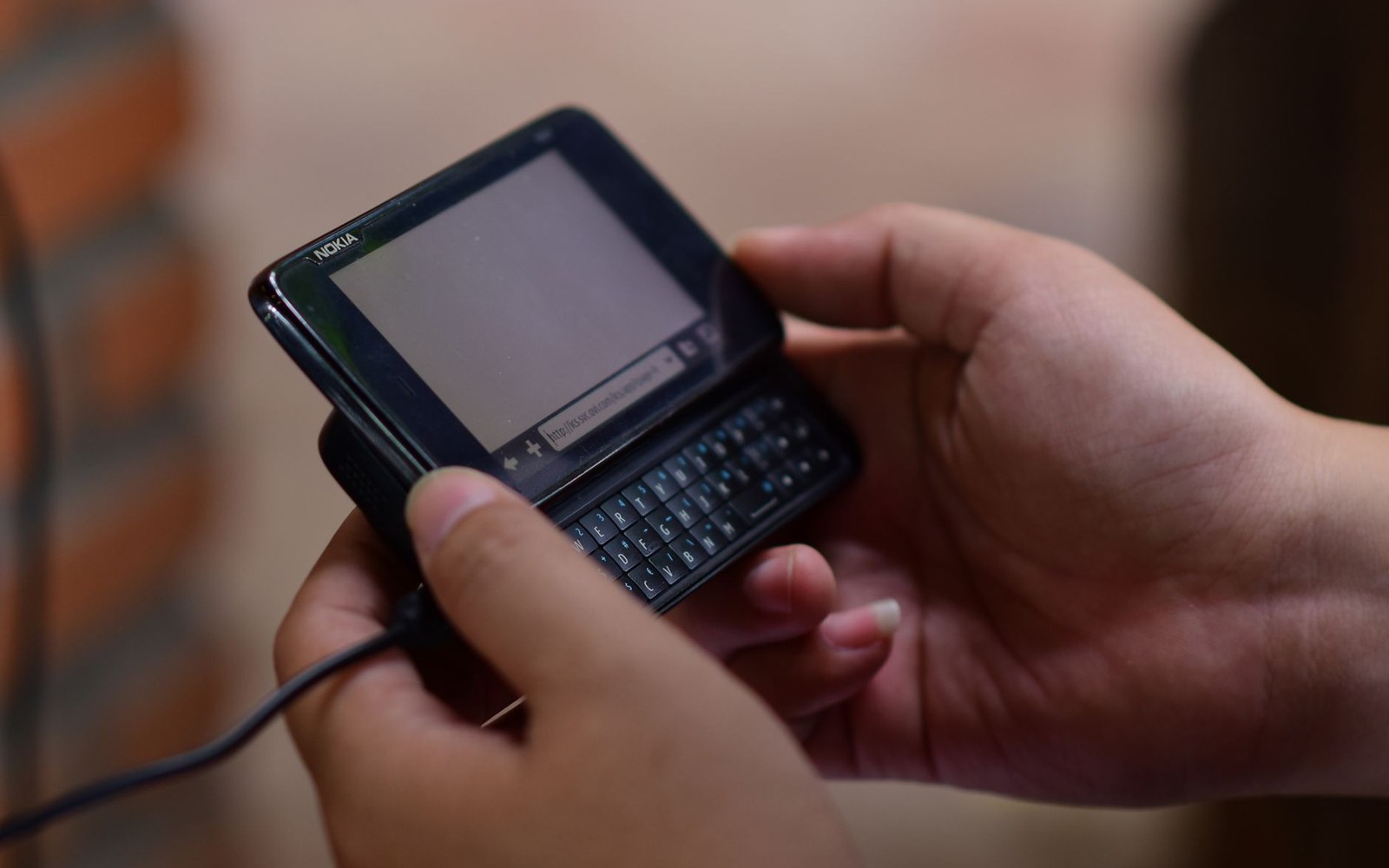 A QWERTY-keyboard handset face-up on a surface