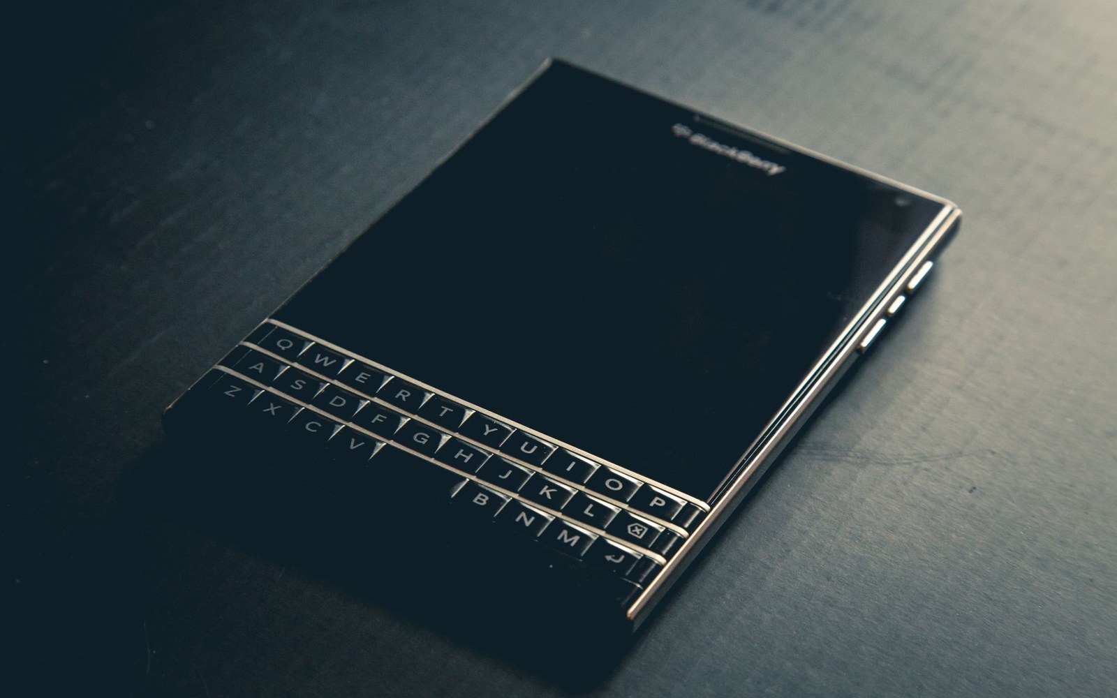 A closed black notebook on a desk